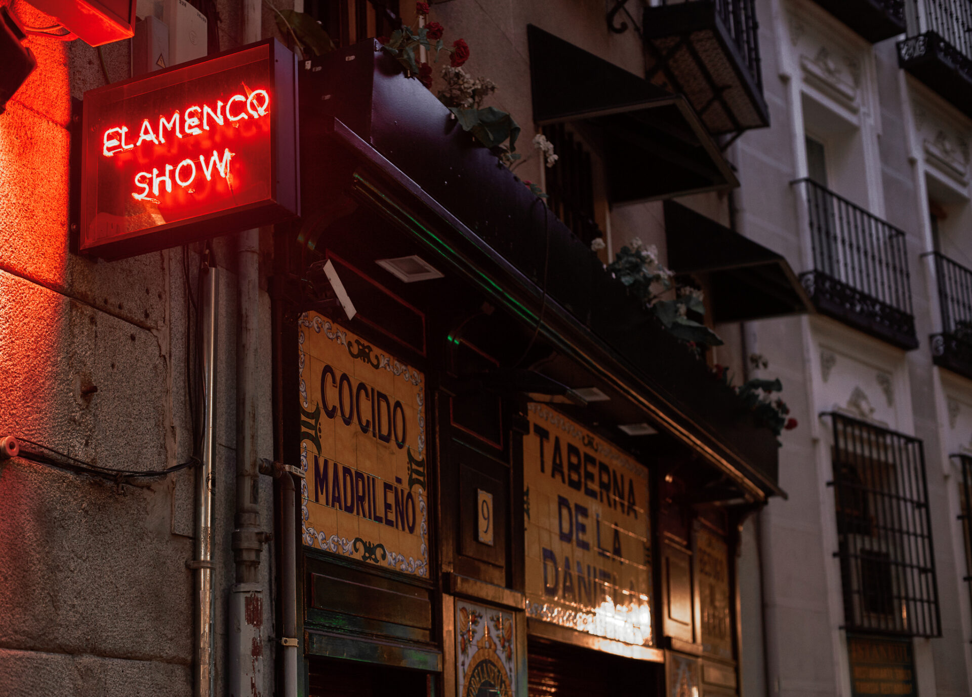 A light up "Flamenco Show" sign outside a vintage tavern in Madrid, Spain