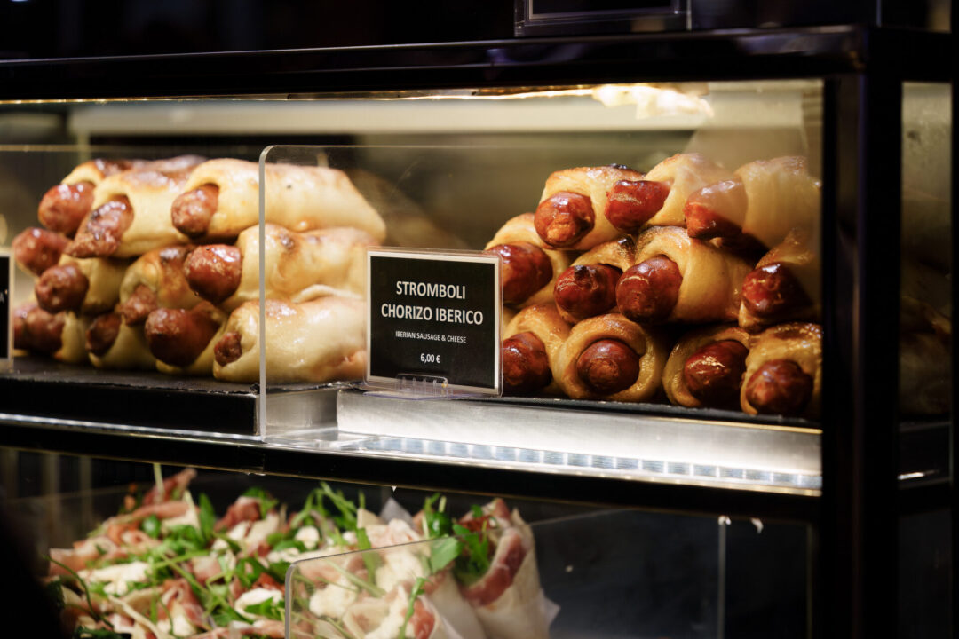 A display case with Iberian sausage rolls in Mercado de San Miguel in Madrid, Spain