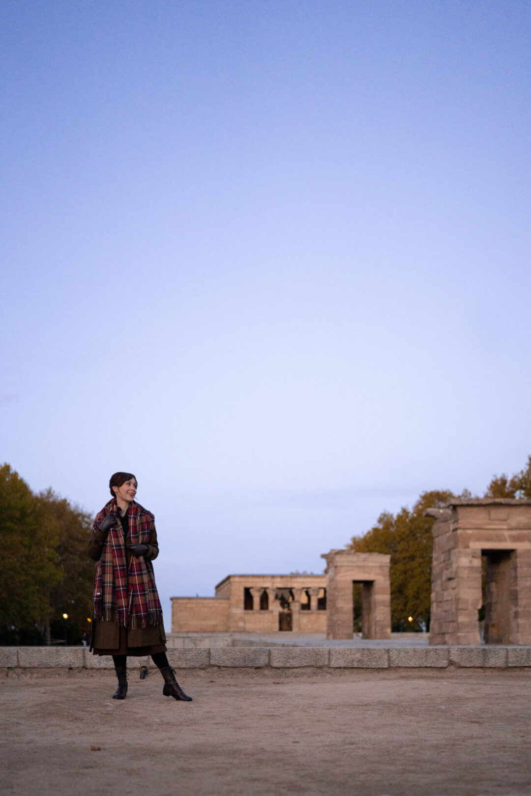 Things to Do In Madrid, Spain: Travel Blogger Jordan Gassner standing and smiling near Templo de Debod at sunrise in Madrid, Spain