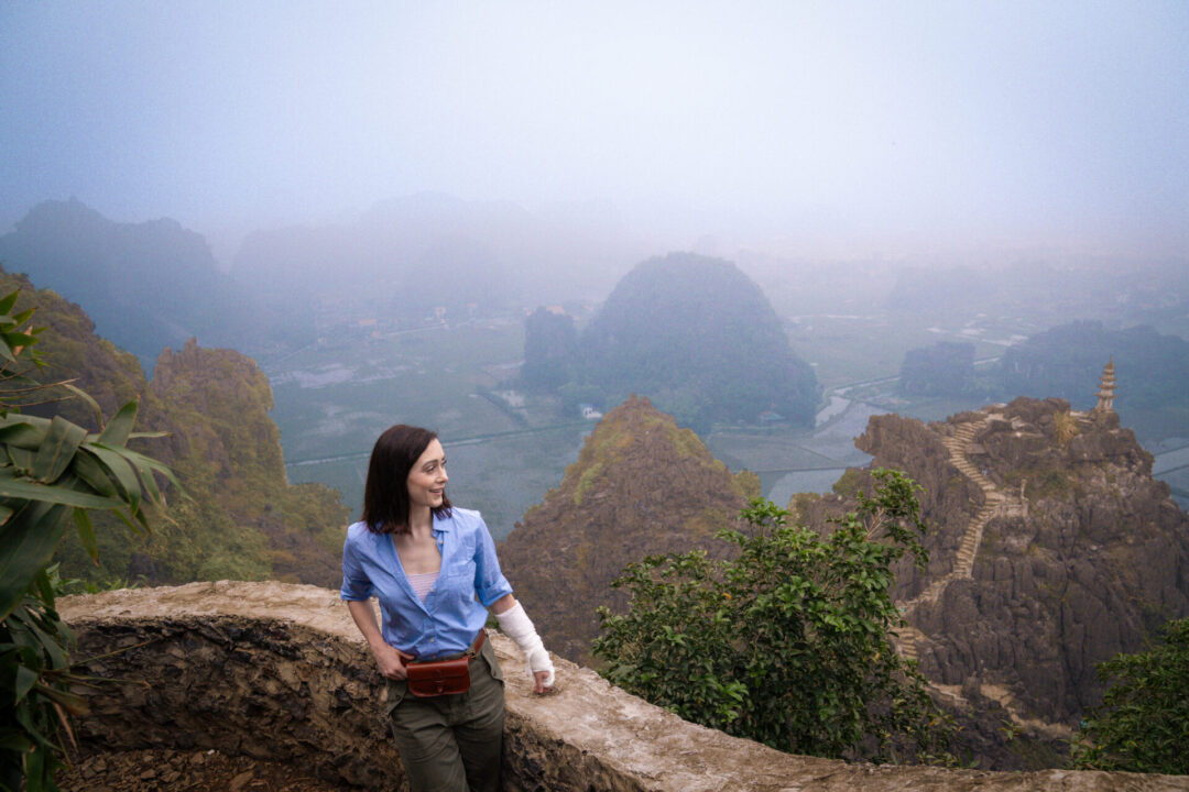Travel Blogger Jordan Gassner standing at a lookout at Hang Mua in Ninh Binh, Vietnam 