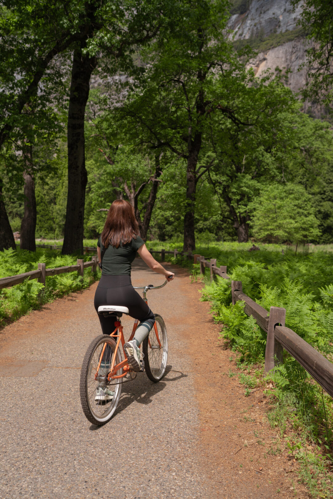 Travel Blogger Jordan Gassner riding a bike along a path on a Yosemite weekend trip