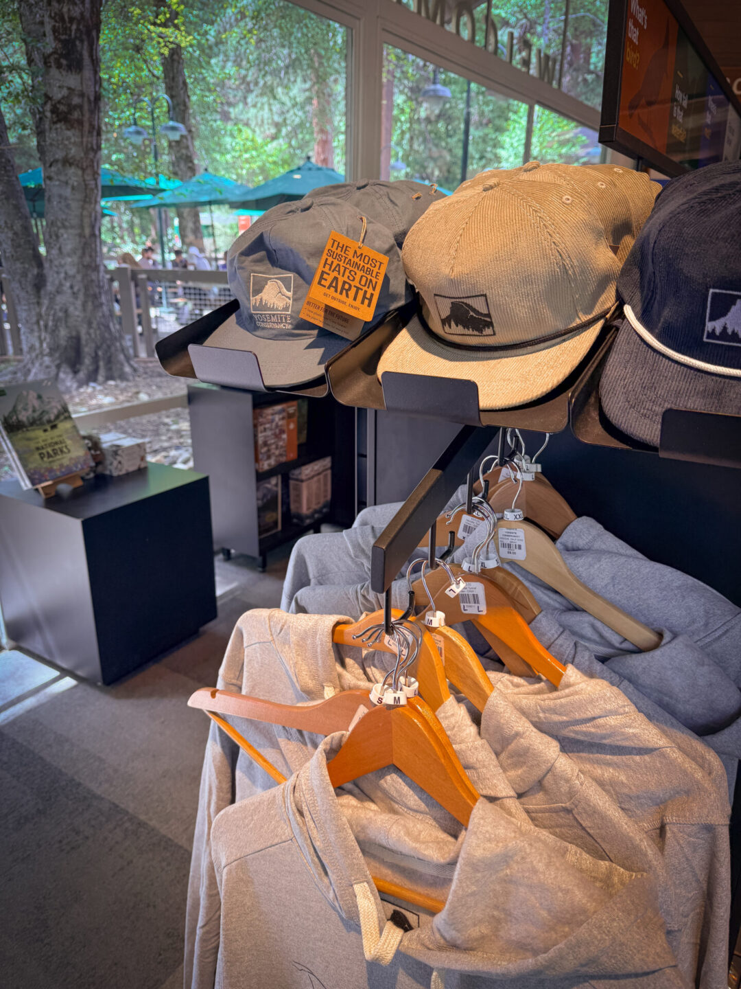 A display of shirts, sweatshirts, and hats inside the Welcome Center at Yosemite National Park