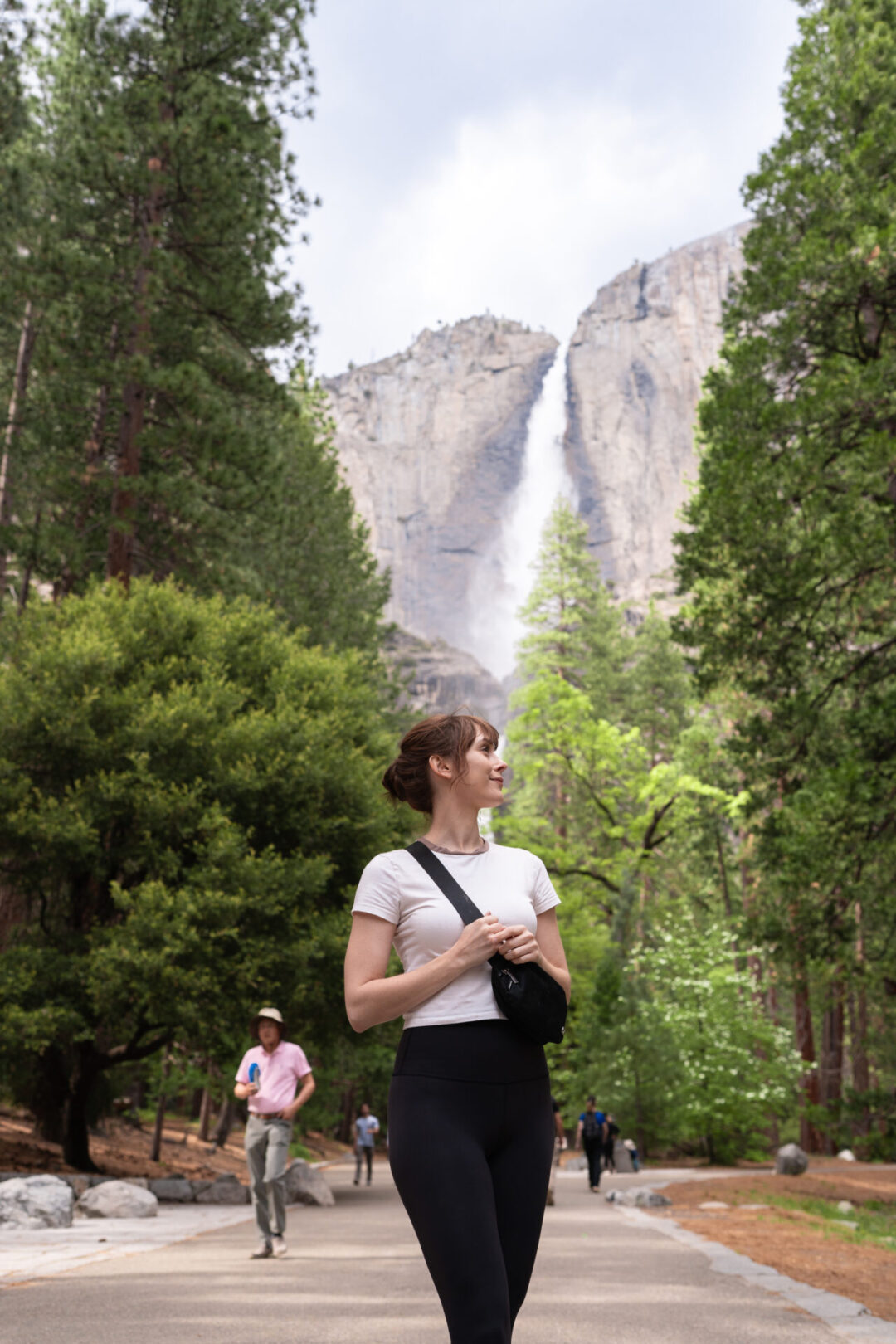 Travel Blogger Jordan Gassner looking behind her along a crowded trail leading up to Lower Yosemite Falls