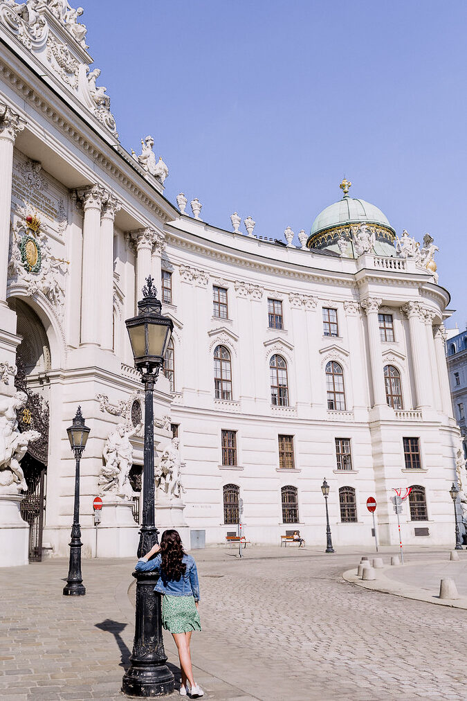 Travel Blogger Jordan Gassner standing in front of Michaelerplatz in Vienna, Austria