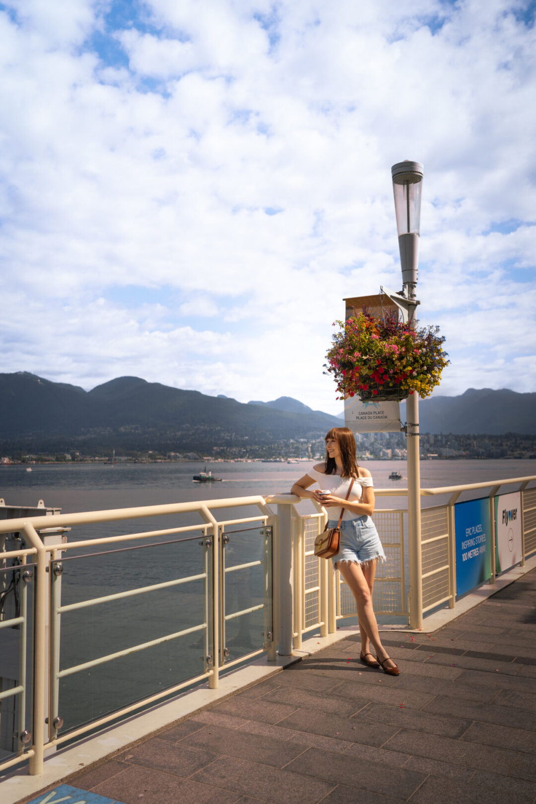 Travel Blogger Jordan Gassner looking out toward the water from Canada Place in Downtown Vancouver, Canada
