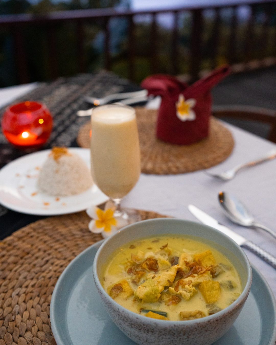 A curry dish, a side of rice, and a pina colada from Lelewatu Resort in Sumba Indonesia