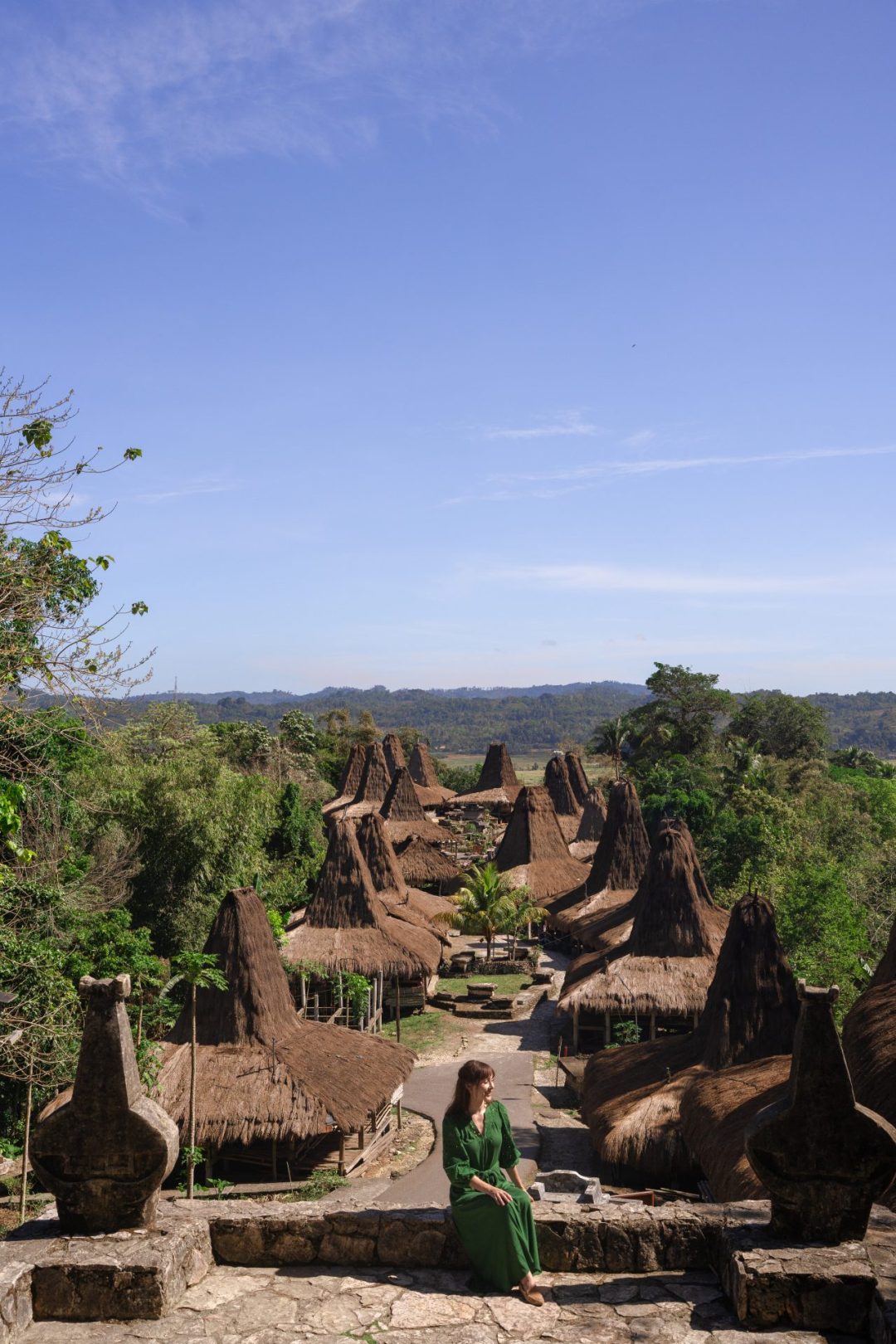 Travel Blogger Jordan Gassner sitting at a lookout point at the top of Prai Ijing Village in Sumba, Indonesia