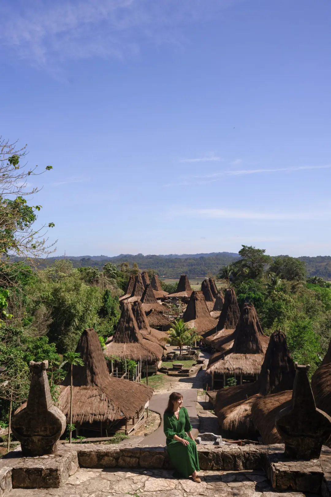 Travel Blogger Jordan Gassner sitting at a lookout point at the top of Prai Ijing Village in Sumba, Indonesia