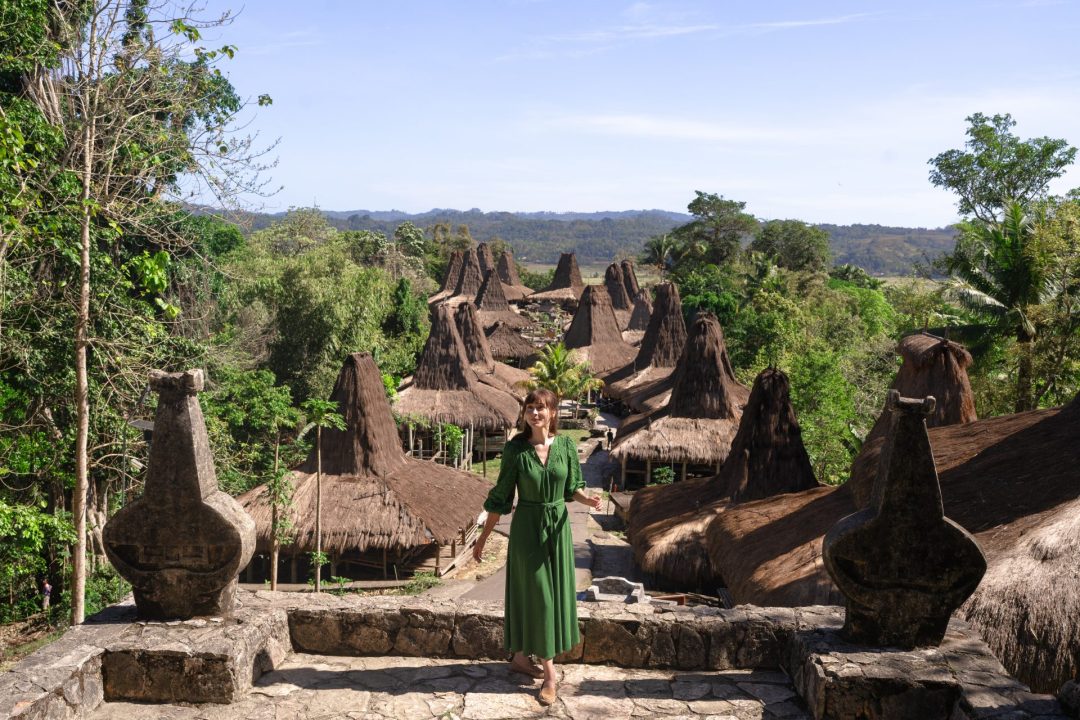 Travel Blogger Jordan Gassner smiling from the top of Prai Ijing, one of the most popular traditional villages in Sumba Indonesia