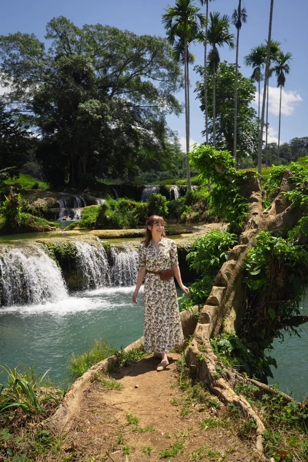 Travel Blogger Jordan Gassner smiling in front of Waikelo Sawah Waterfall in West Sumba, Indonesia