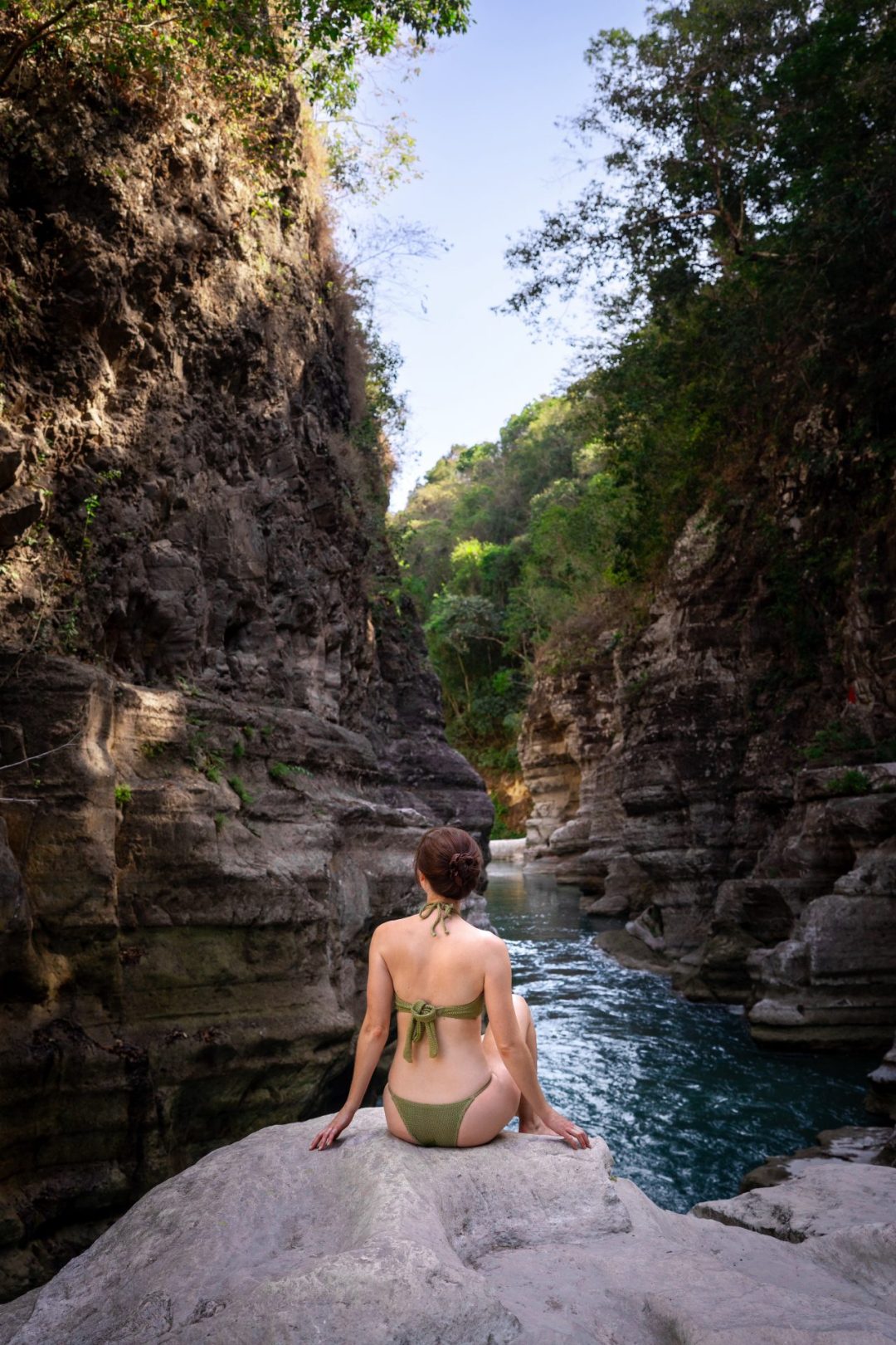 Travel Blogger Jordan Gassner looking out toward the water between the canyons carved by Tanggedu Waterfall in Sumba Indonesia