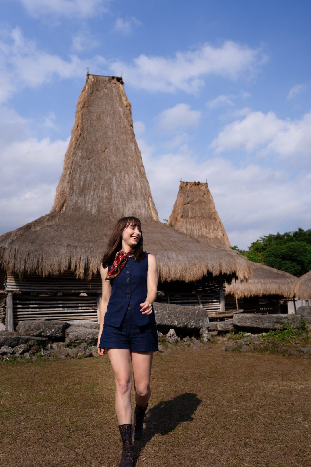 Travel Blogger Jordan Gassner smiling and walking through the village of Waikaroko in Sumba, Indonesia