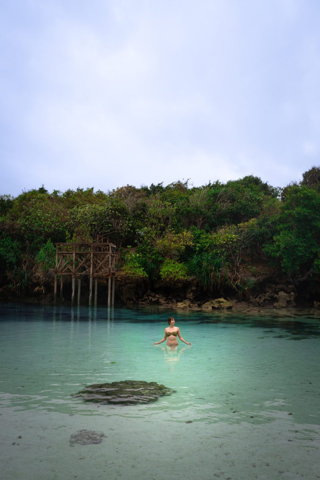 Travel Blogger Jordan Gassner wading through Waikuri Lagoon at low tide in Sumba, Indonesia
