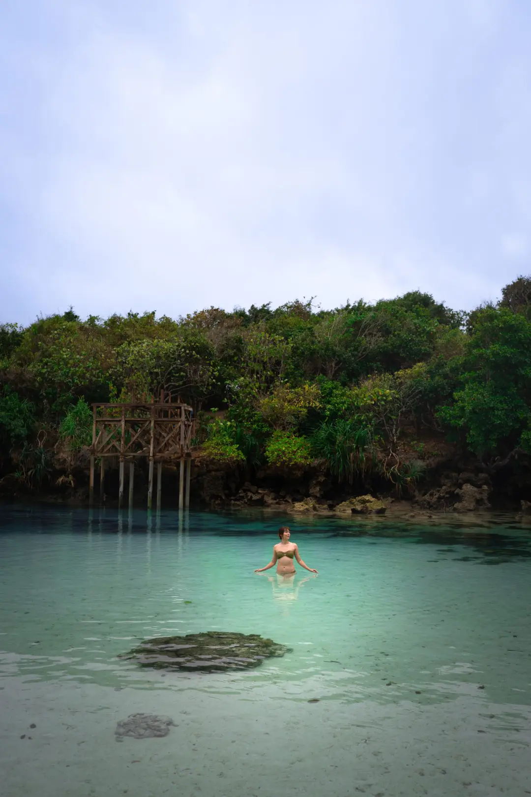 Travel Blogger Jordan Gassner wading through Waikuri Lagoon at low tide in Sumba, Indonesia