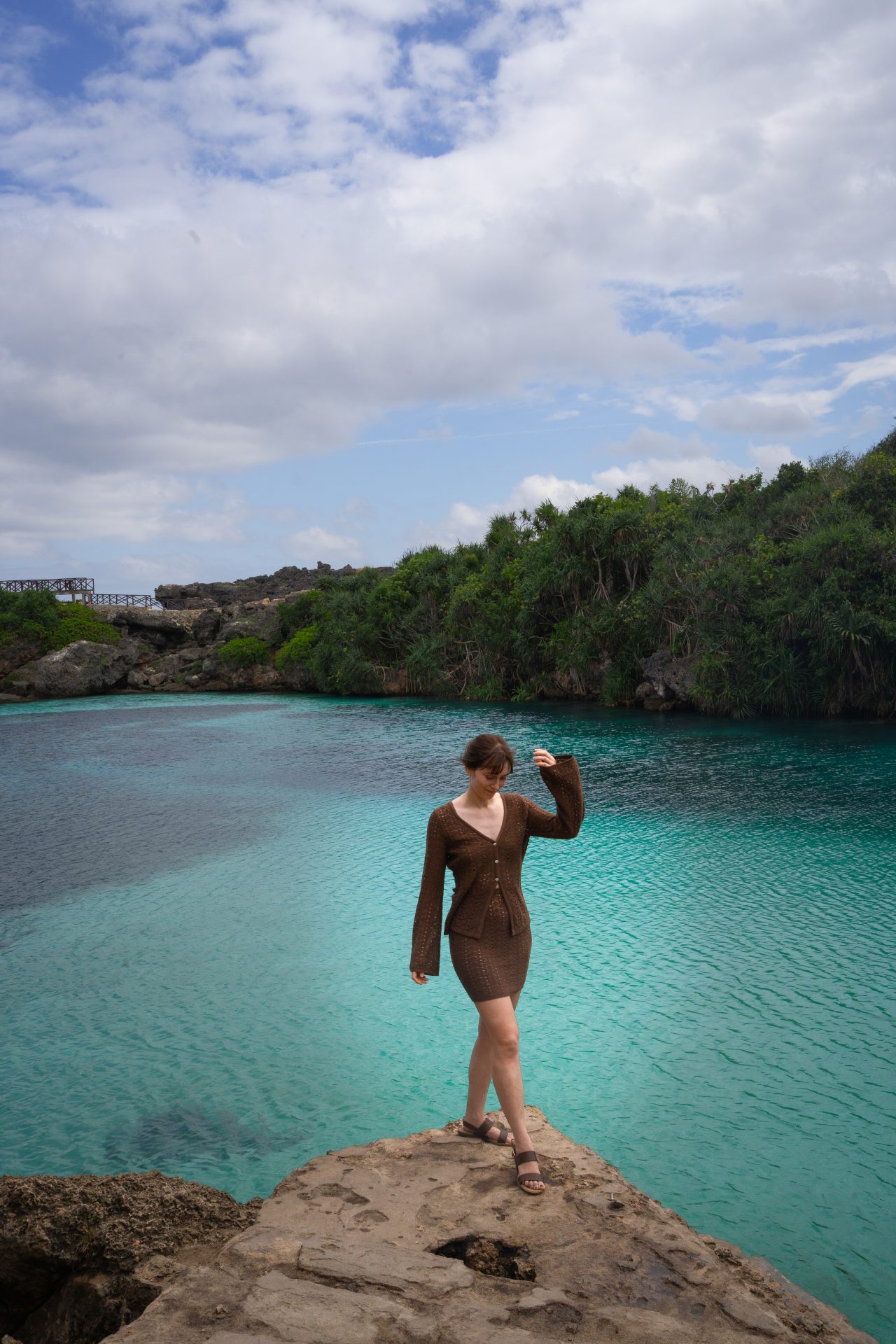 Travel Blogger Jordan Gassner standing on an outlook over Waikuri Lagoon in Sumba Indonesia