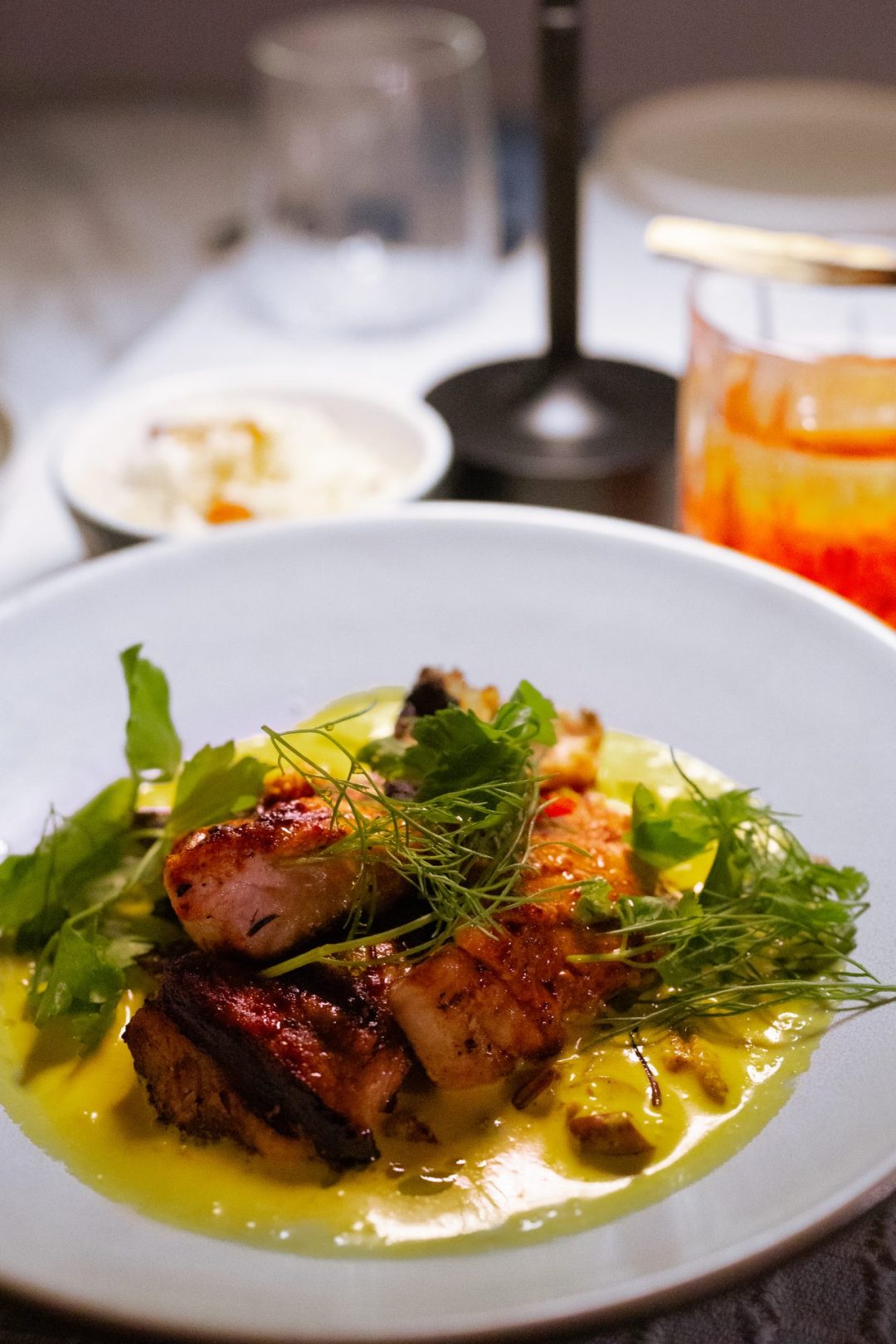 A local curry and negroni from Apicine Restaurant at Cap Karoso resort in Sumba, Indonesia at sunset