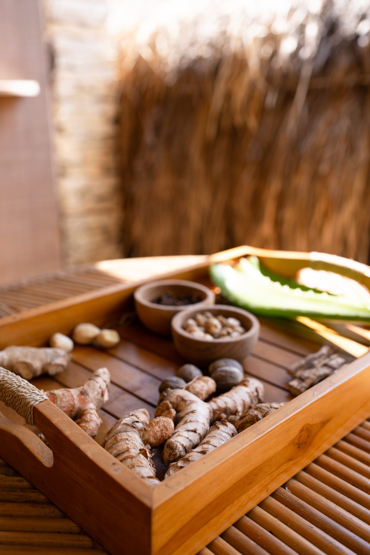 A tray of ginger alongside a few bowls of local nuts and seeds at Malala Spa front desk at Cap Karoso Resort in Sumba, Indonesia