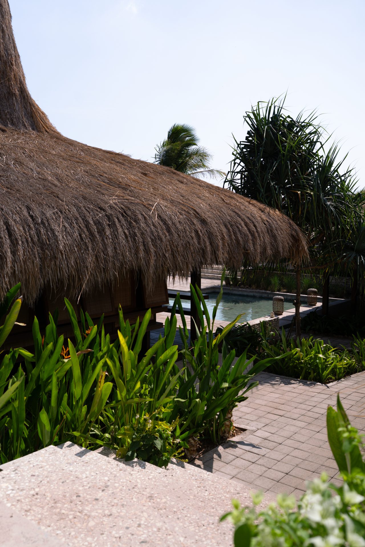 A fountain near some traditional inspired structures at Malala Spa at Cap Karoso resort in Sumba, Indonesia