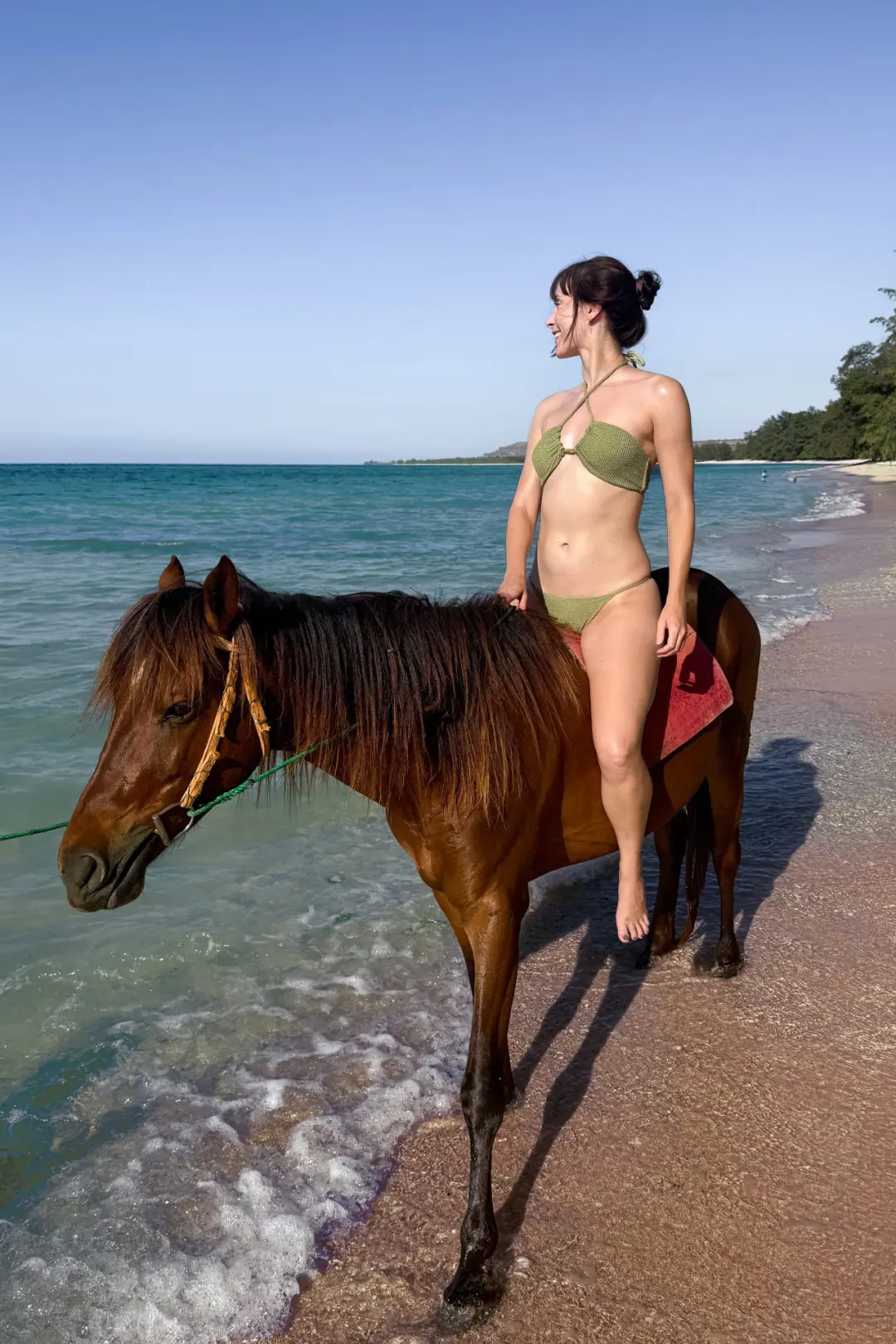 Travel Blogger Jordan Gassner riding a horse along a beach in Sumba, Indonesia