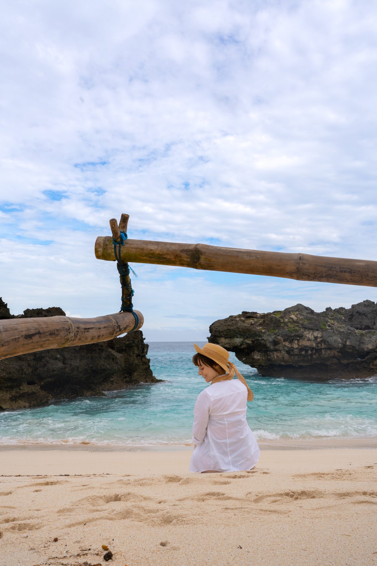 Travel Blogger Jordan Gassner smiling in a cover-up along Mandorak Beach in Sumba, Indonesia