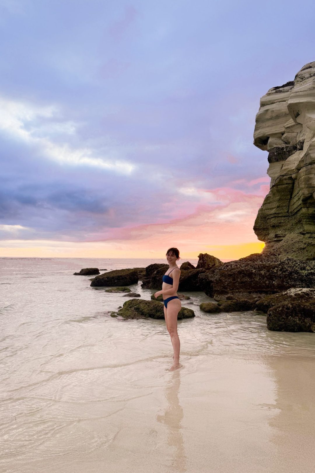 Trael Blogger Jordan Gassner smiling on the beach at sunset in Indonesia