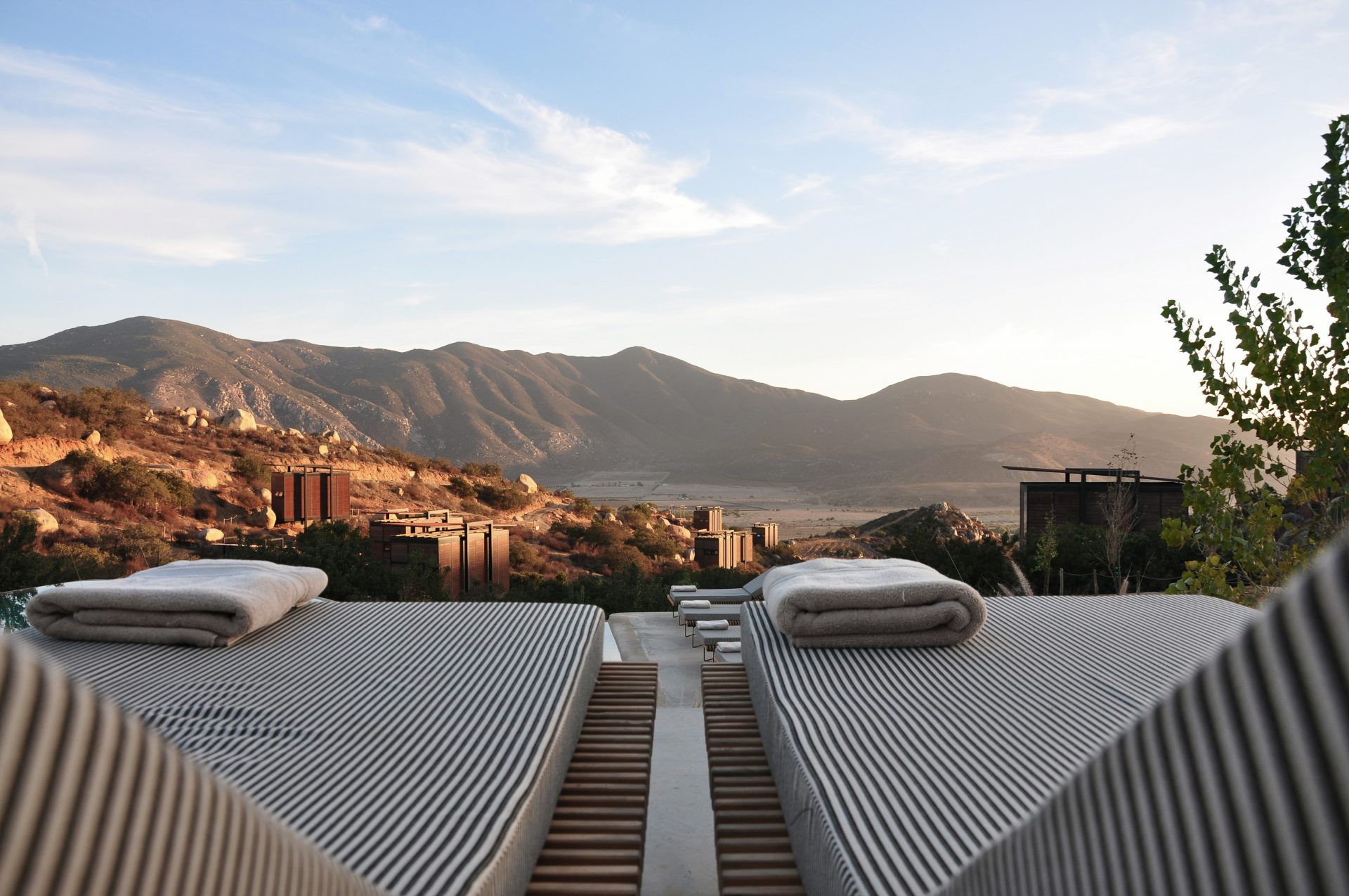 A few lounge chairs at a hotel overlooking Valle de Guadalupe in Mexico