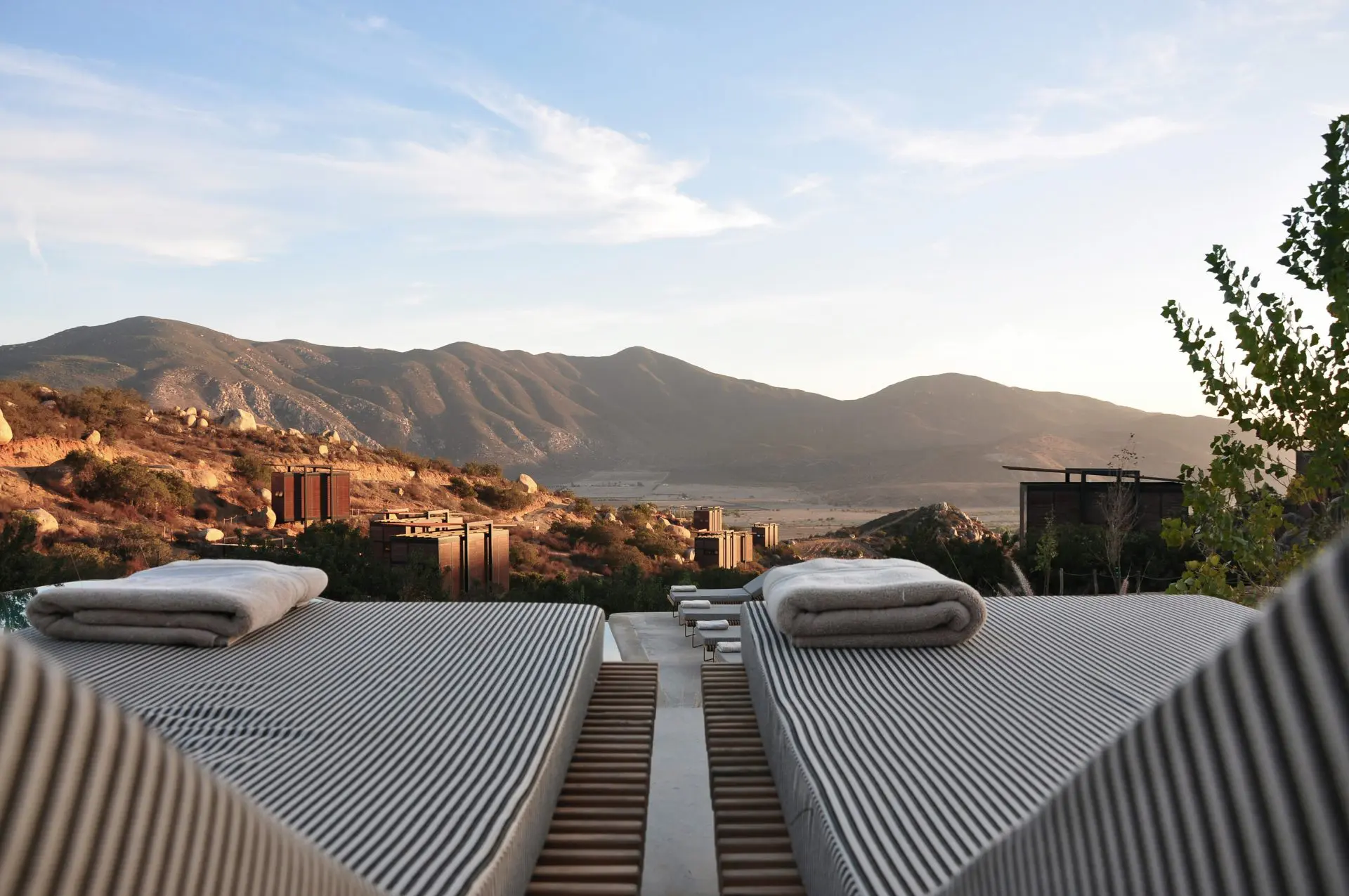 A few lounge chairs at a hotel overlooking Valle de Guadalupe in Mexico