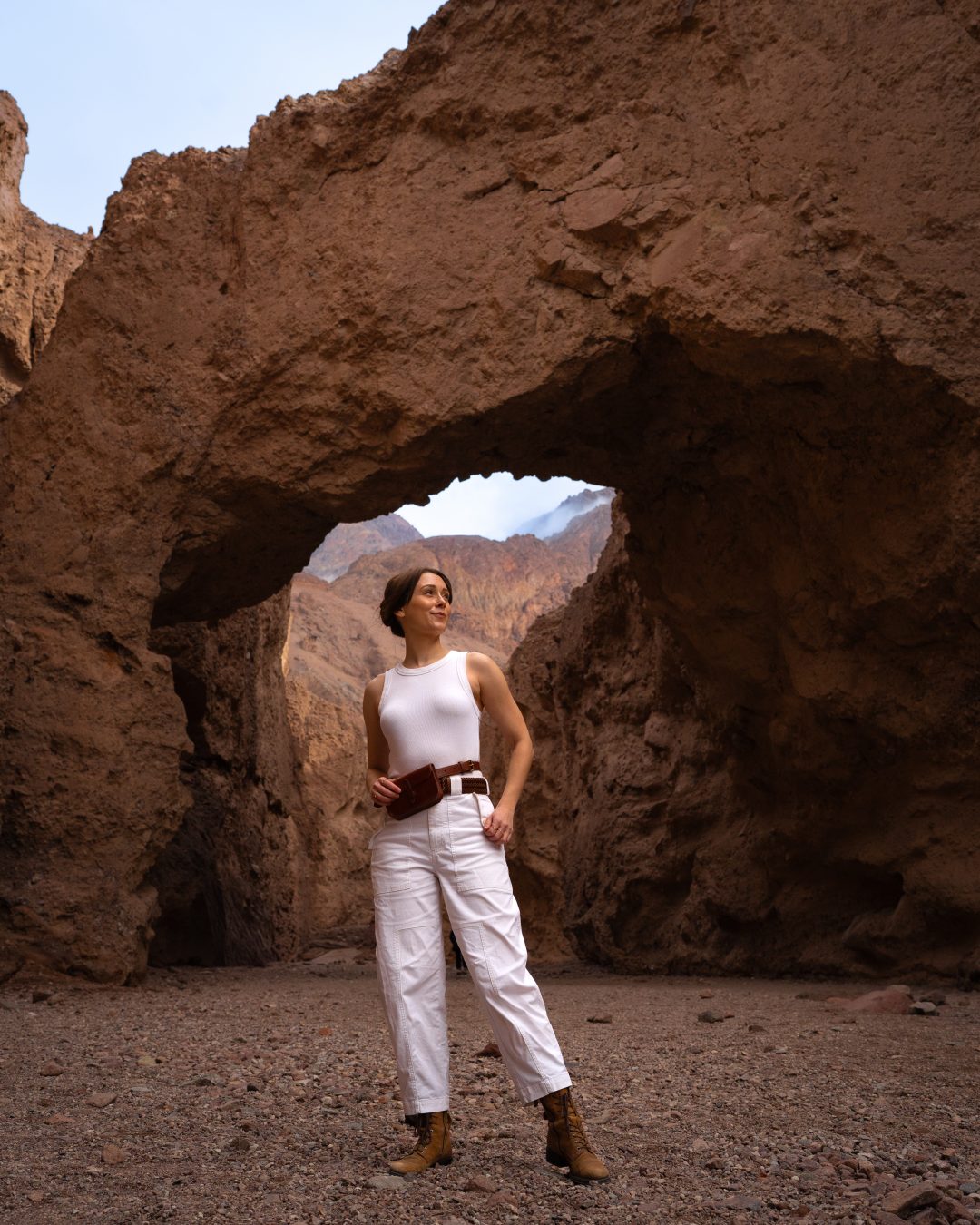 Travel Blogger Jordan Gassner standing underneath Natural Bridge arch while dressed as Padme from Star Wars in Death Valley National Park