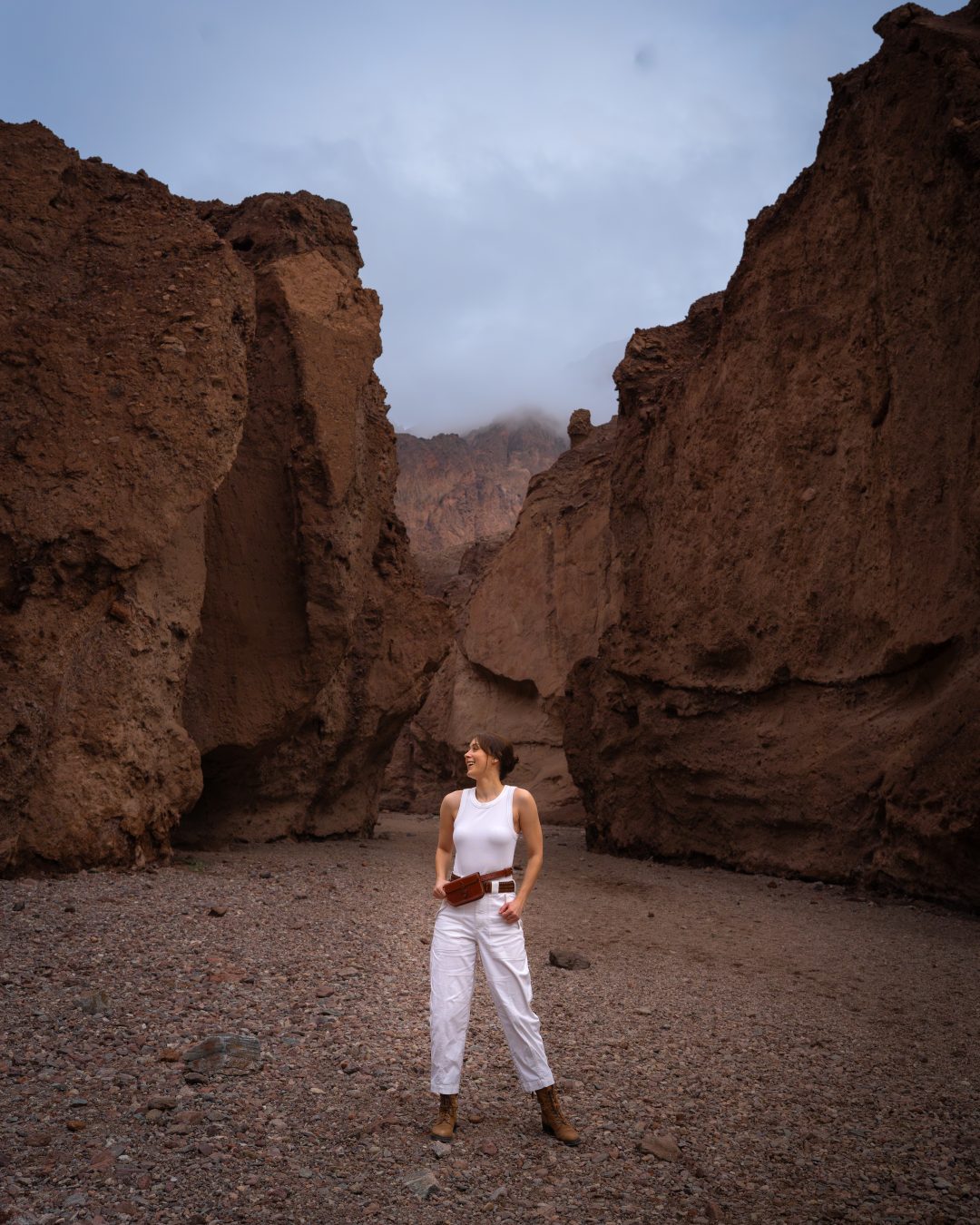 Travel Blogger Jordan Gassner laughing along the trail inside Natural Bridge Canyon in Death Valley National Park in California