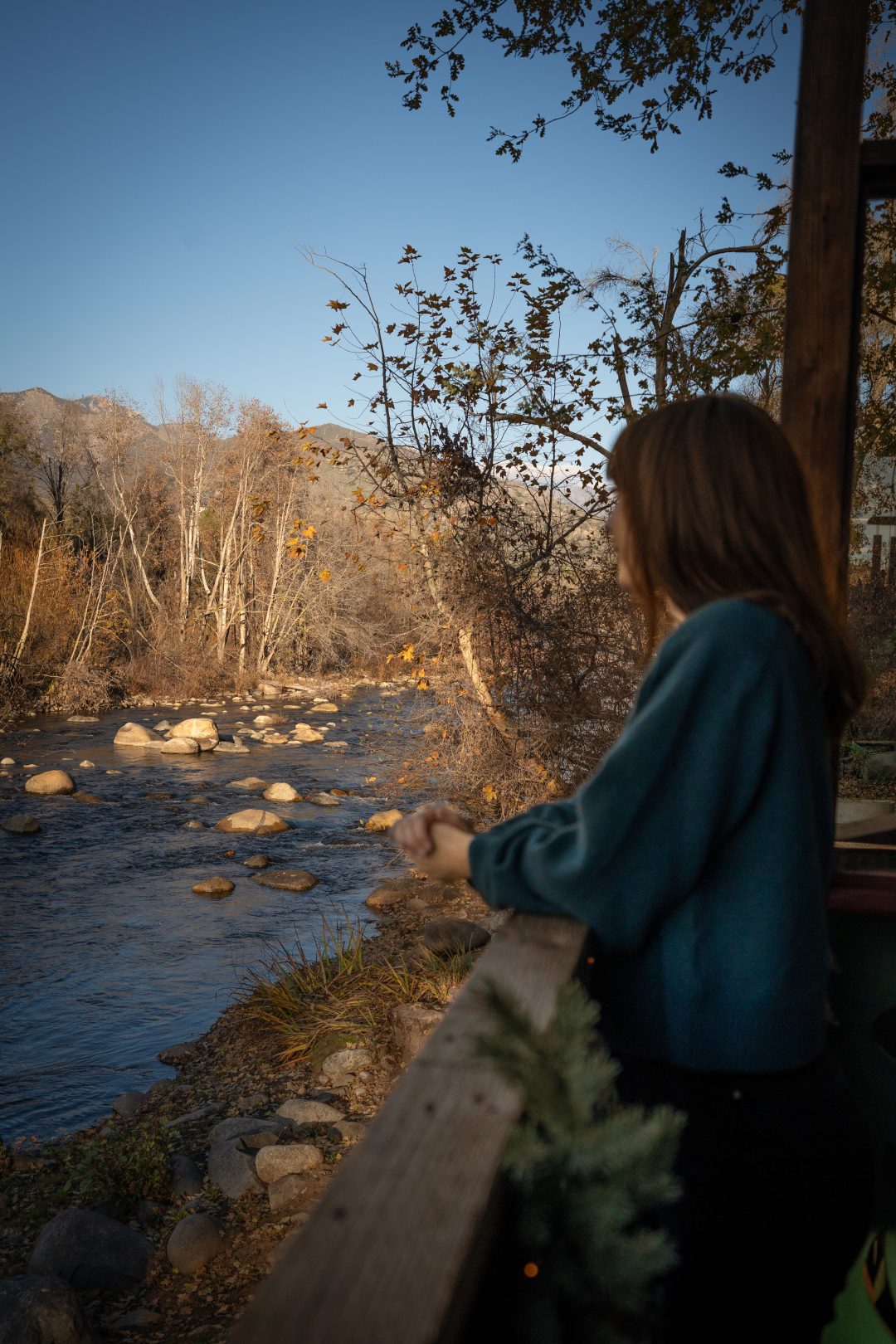 Travel Blogger Jordan Gassner looking out toward the river from a patio in Three Rivers, California near Sequoia National Park