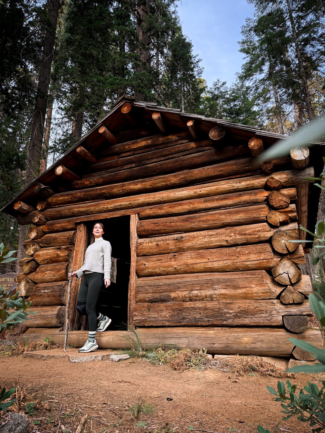 Guide to Sequoia's Best Trails: Travel Blogger Jordan Gassner walking out of Squatter's Cabin in Sequoia National Park