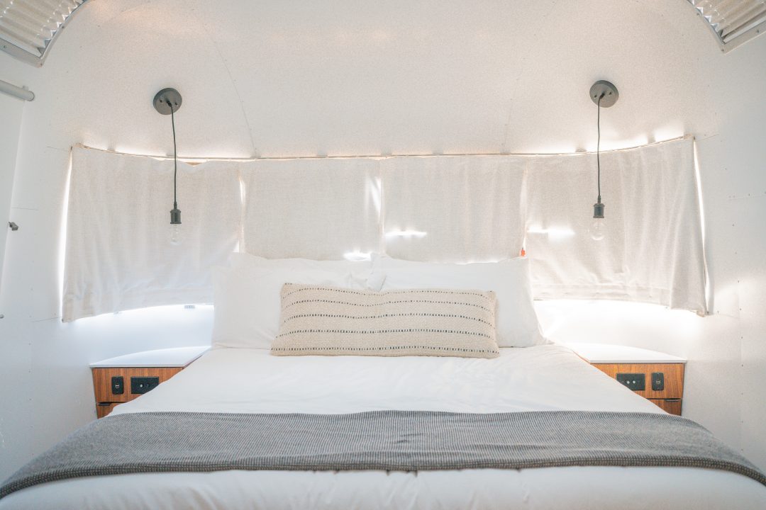 A bed inside a vintage airstream at AutoCamp Sequoia in Three Rivers, California