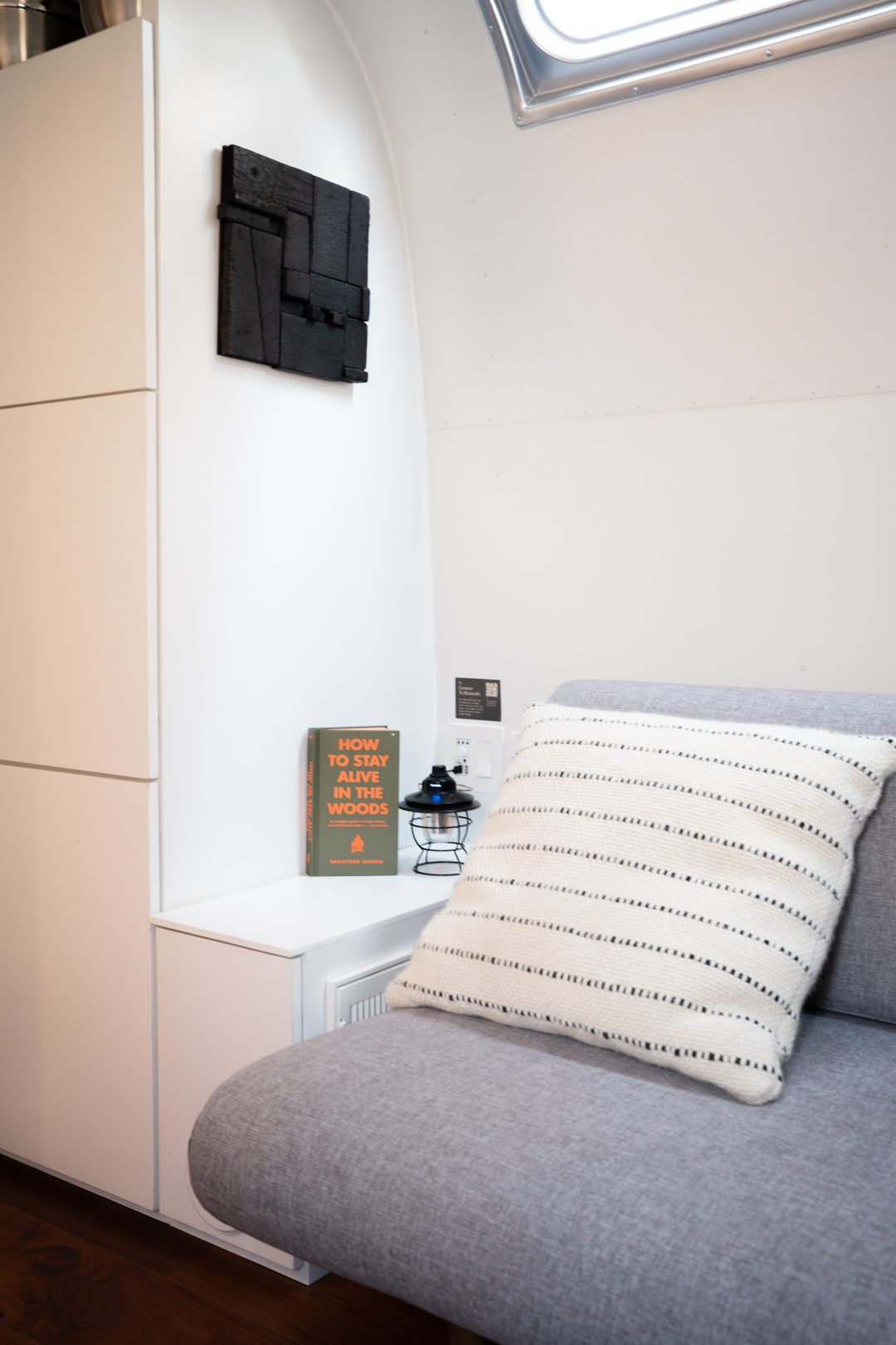 A sofa  inside a vintage airstream at AutoCamp Sequoia in Three Rivers, California