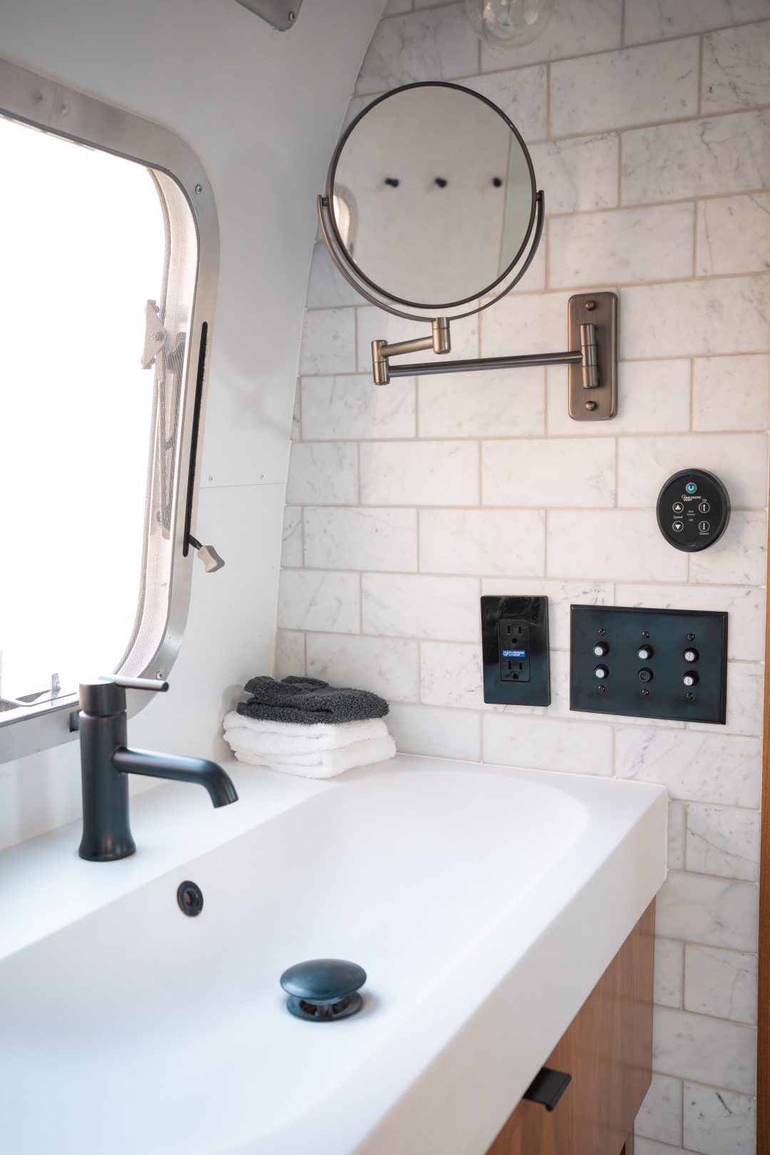 A sink and magnifying mirror inside a vintage airstream at AutoCamp Sequoia in Three Rivers, California