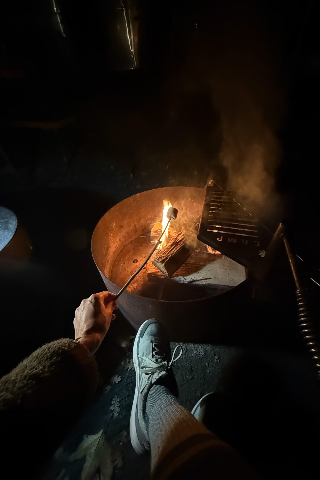 Travel Blogger Jordan Gassner roasting a s'more over a campfire at AutoCamp Sequoia In Three Rivers, California