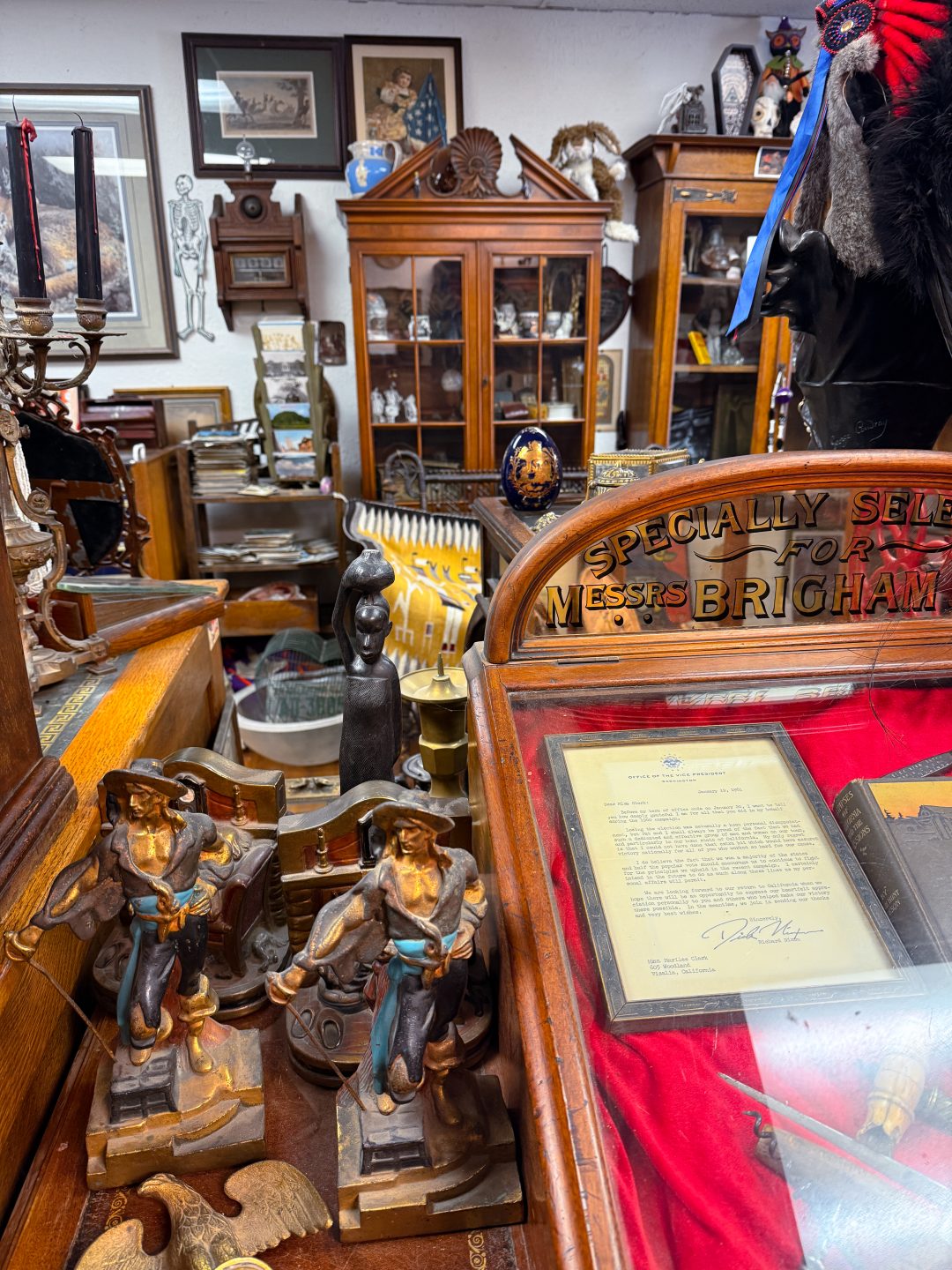 Figurines and other vintage furniture pieces inside Village Antiques in Three Rivers, California
