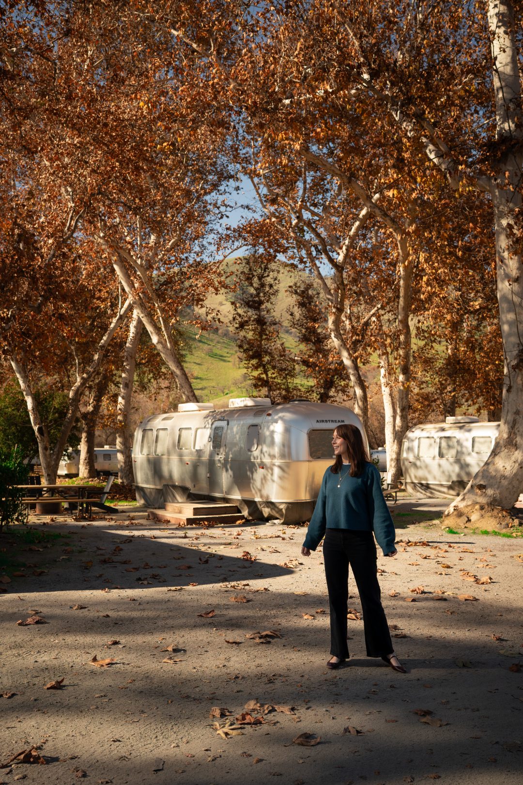Travel Blogger Jordan Gassner standing next to the silver airstreams at AutoCamp in Three Rivers, California near Sequoia National Park