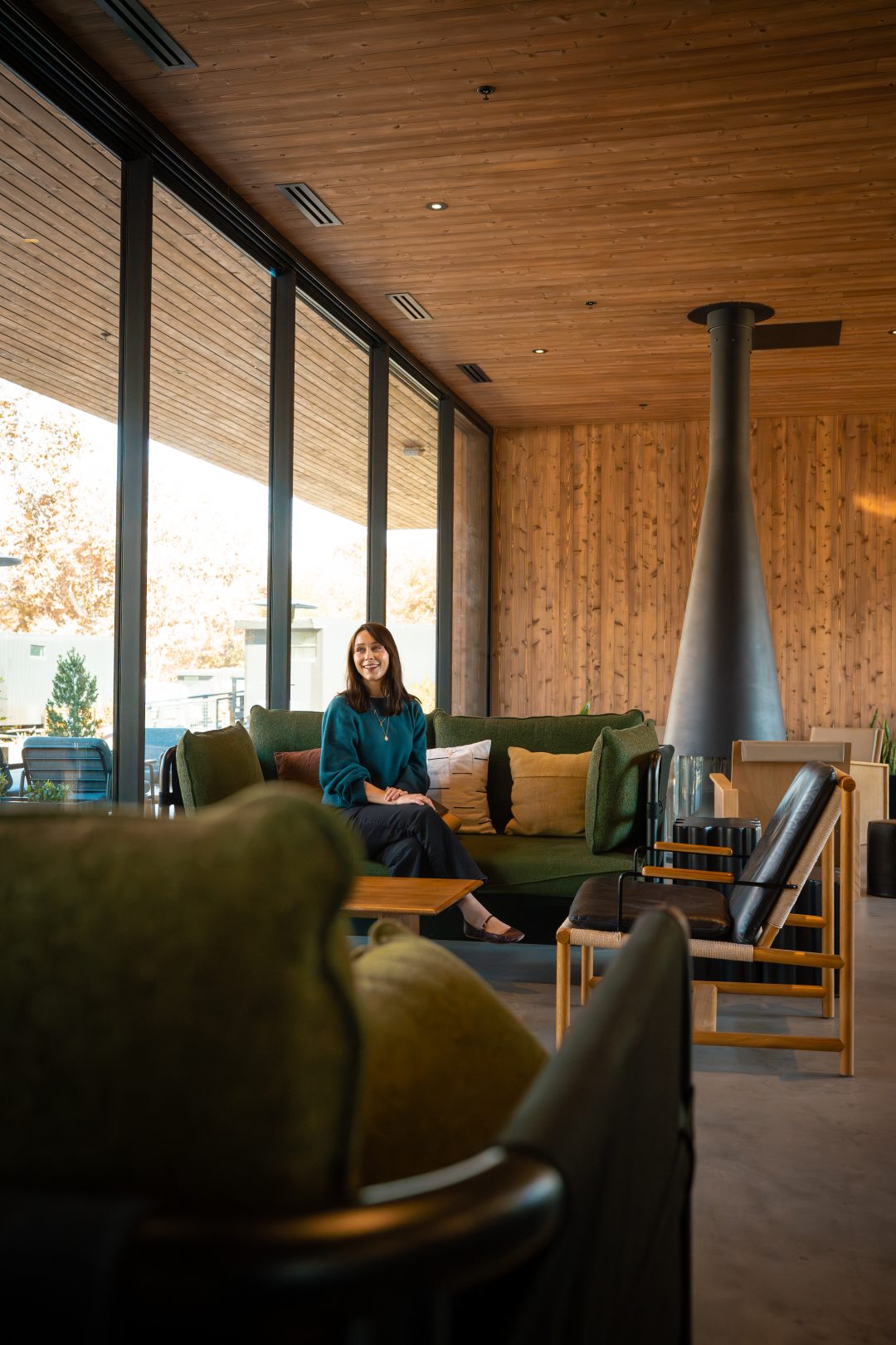 Travel Blogger Jordan Gassner smiling from the lobby at AutoCamp in Three Rivers, California near Sequoia National Park