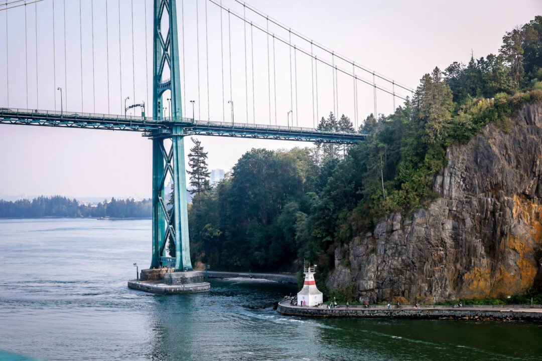 A view of Lions Gate Bridge going into Stanley Park from the water in Vancouver, Canada