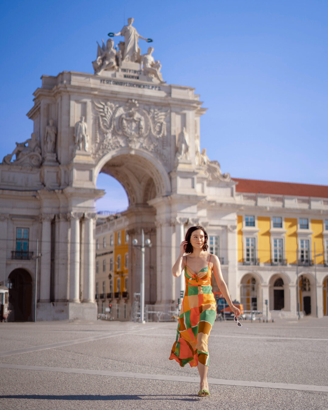 10 Best Solo Travel Countries For First-Timers: Travel Blogger Jordan Gassner walking through the main plaza on a sunny day in Lisbon, Portugal