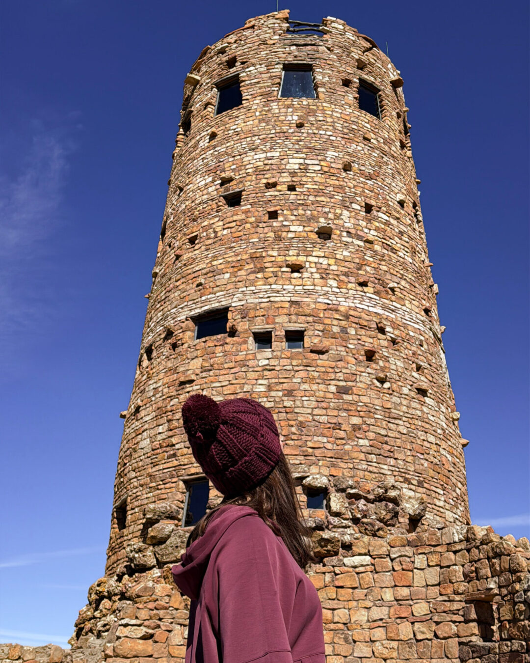 Grand Canyon Mistakes to Avoid: Treating it as a quick stop. Photo is a close-up of Travel Blogger Jordan Gassner turning to look at the Desert View Watchtower 