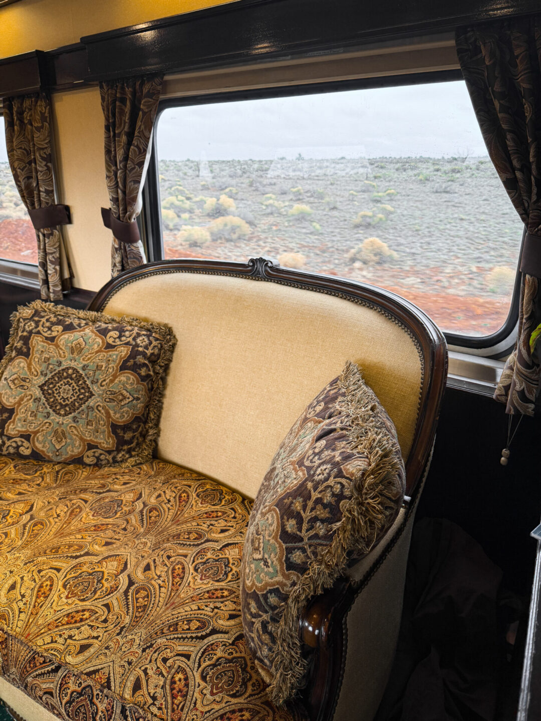 A patterned loveseat inside a luxury parlor car aboard the Grand Canyon Railway