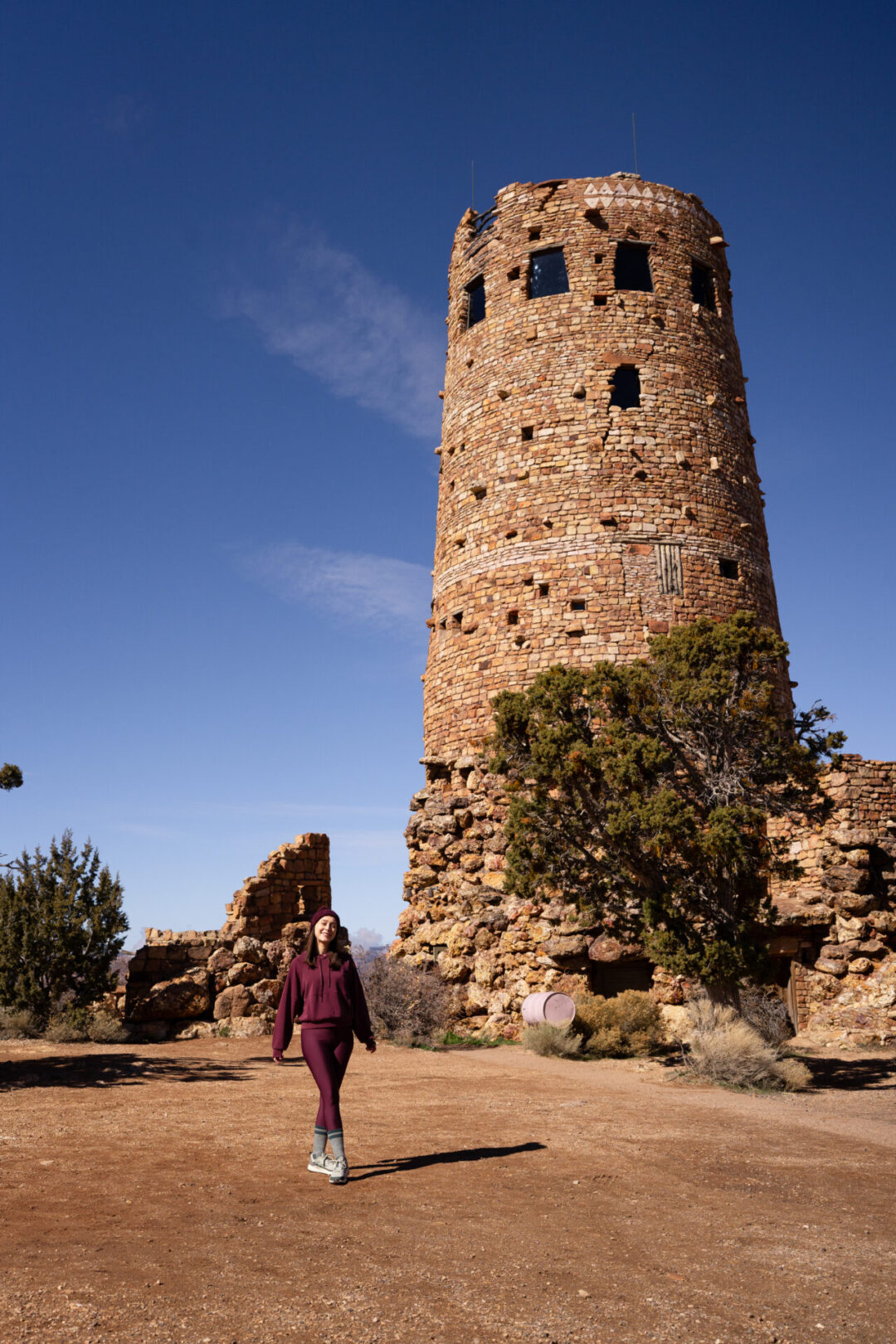 Travel Blogger Jordan Gassner smiling while standing at the base of Desert View Tower in the Grand Canyon in Arizona, USA