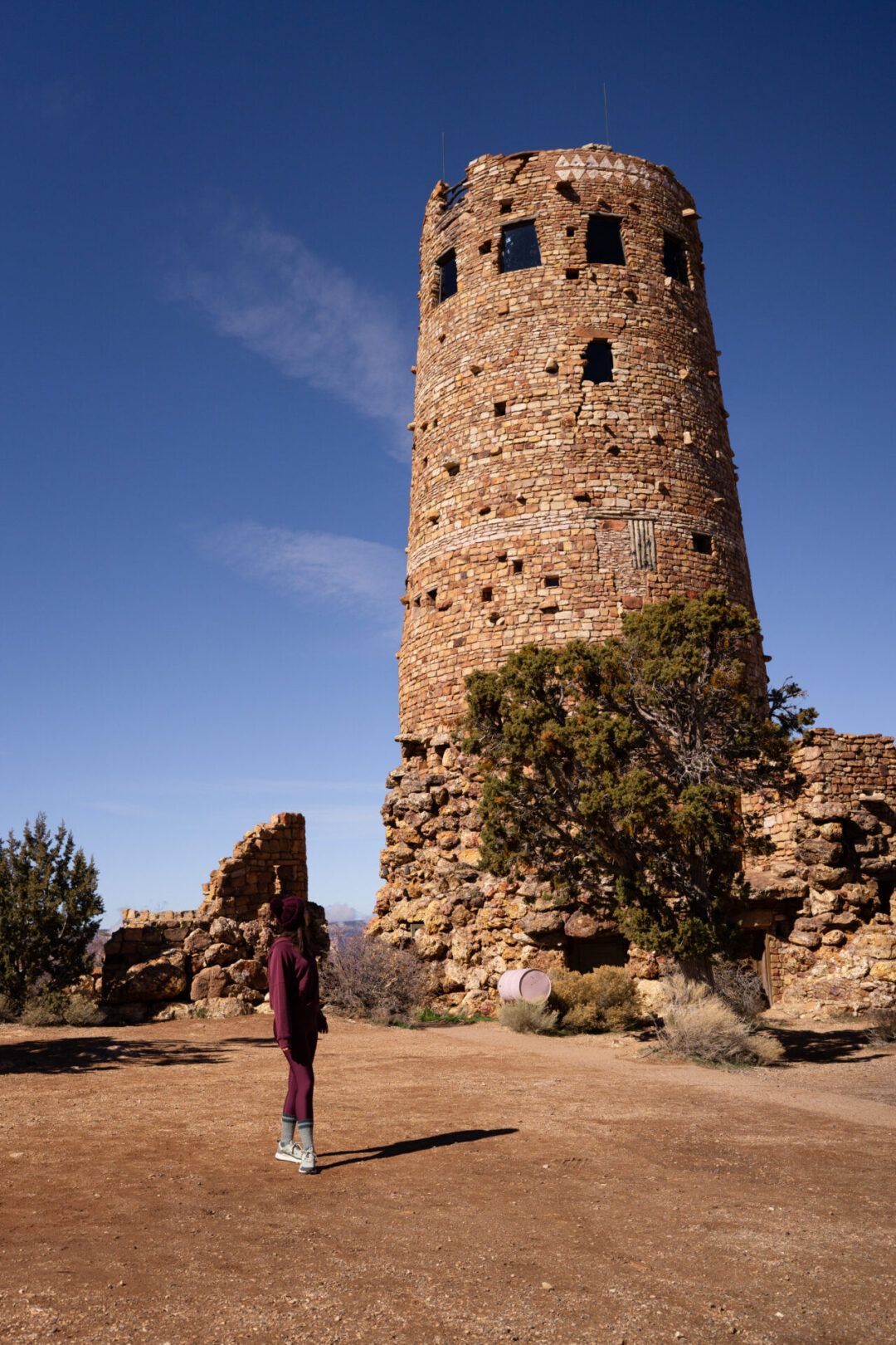 Travel Blogger Jordan Gassner turning to look at the Desert View Watchtower and smiling