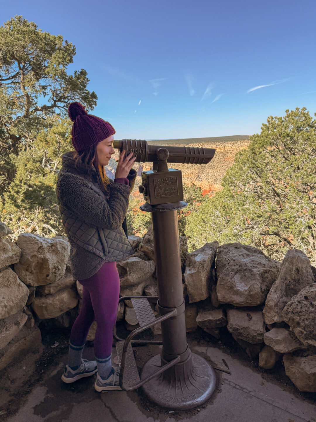 Travel Blogger Jordan Gassner to the right and through a built-in set of binoculars at Hermit's Rest in the Grand Canyon