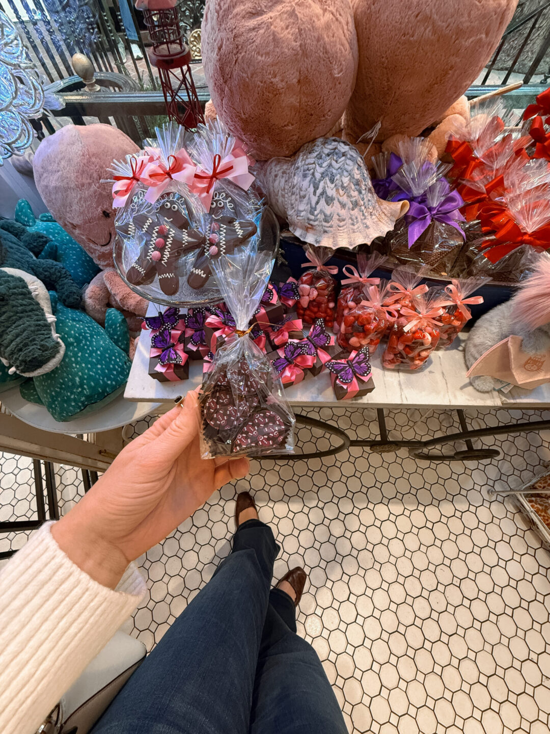 Travel Blogger Jordan Gassner holding some Valentines Day themed dairy free truffles inside La Rue du Chocolat at Peppertree Lane in Laguna Beach, California