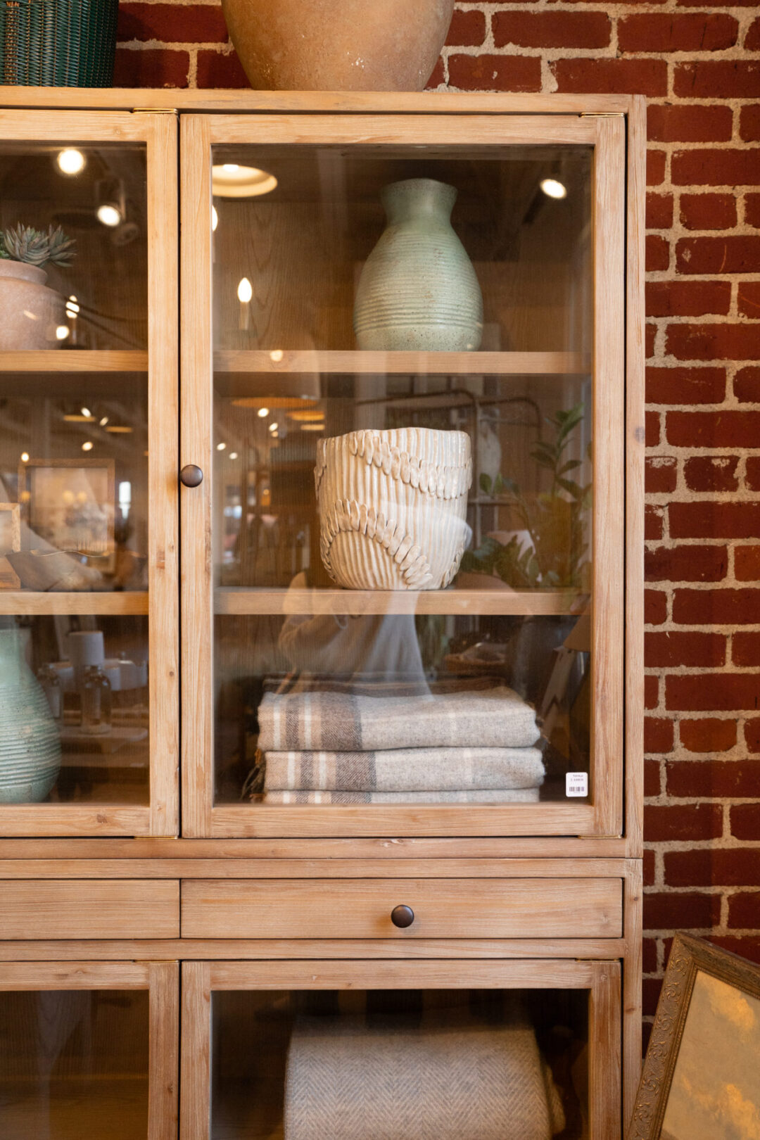 An armoire with ceramics and towels inside Tuvalu, a home goods store along Forest Avenue in Laguna Beach, California