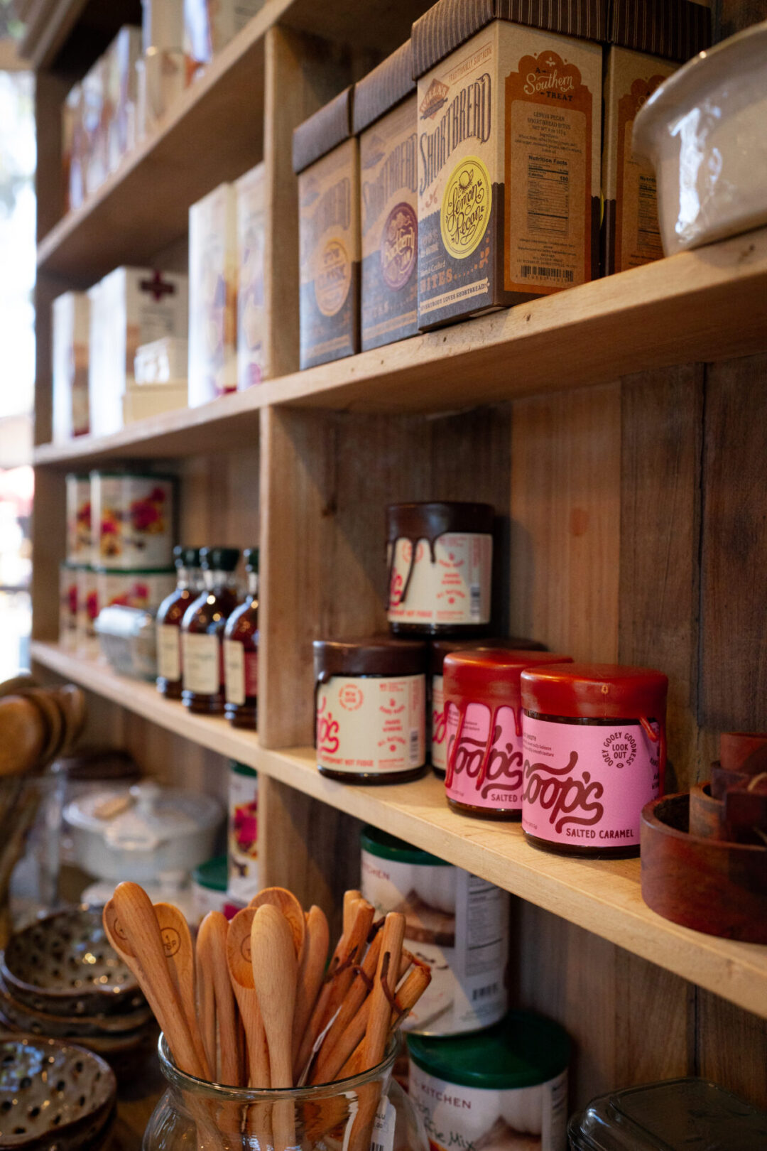 The pantry with honey, jams, and scone mixes inside Tuvalu, a home goods store along Forest Avenue in Laguna Beach, California