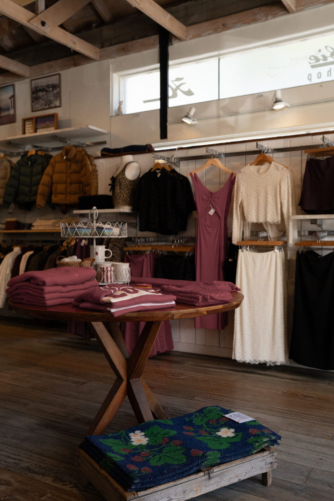 A table and wall of women's clothing inside Hobie Surf Shop in Laguna Beach, California