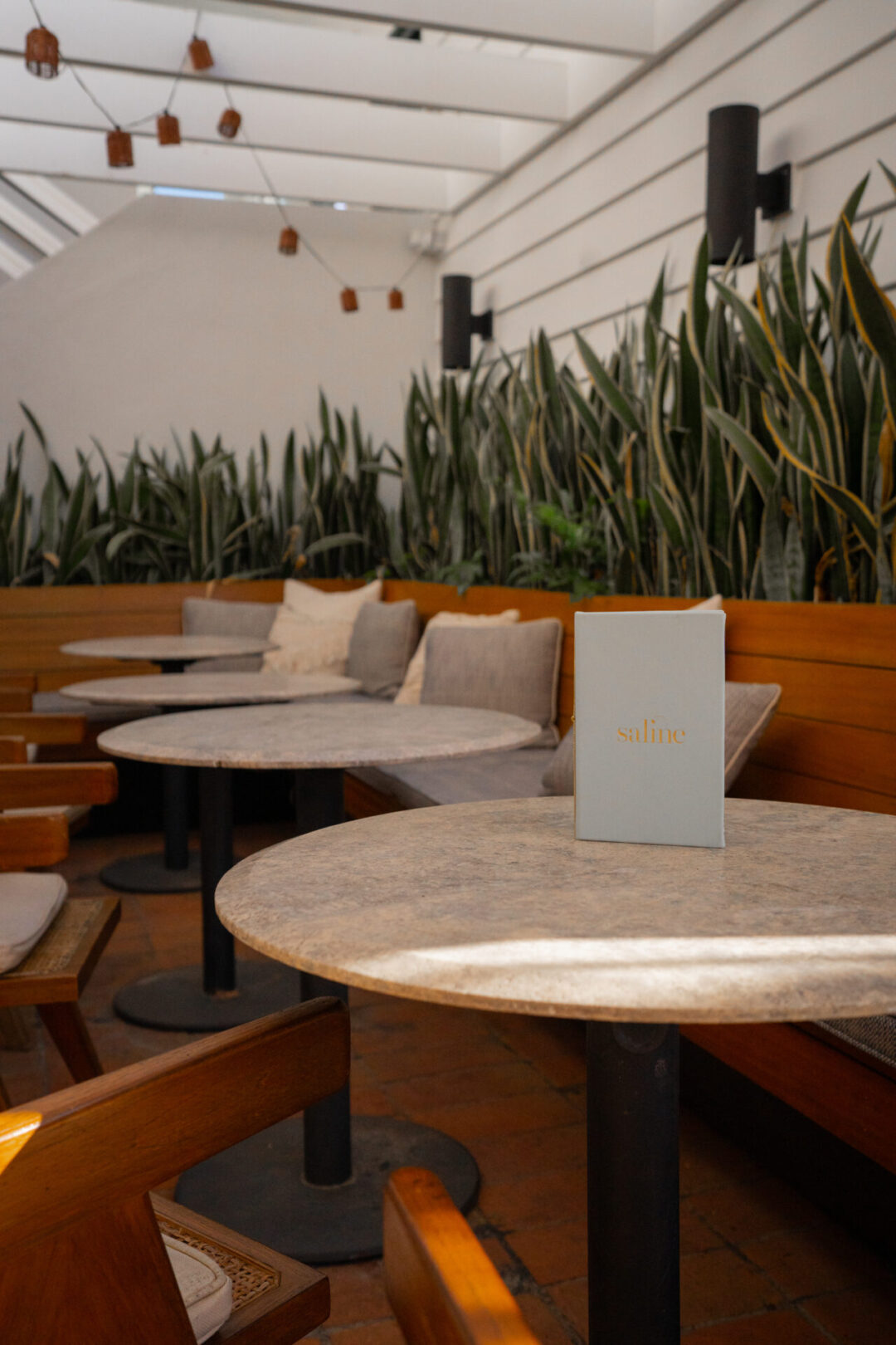A few empty tables amid the al fresco dining space at Saline in Laguna Beach, California